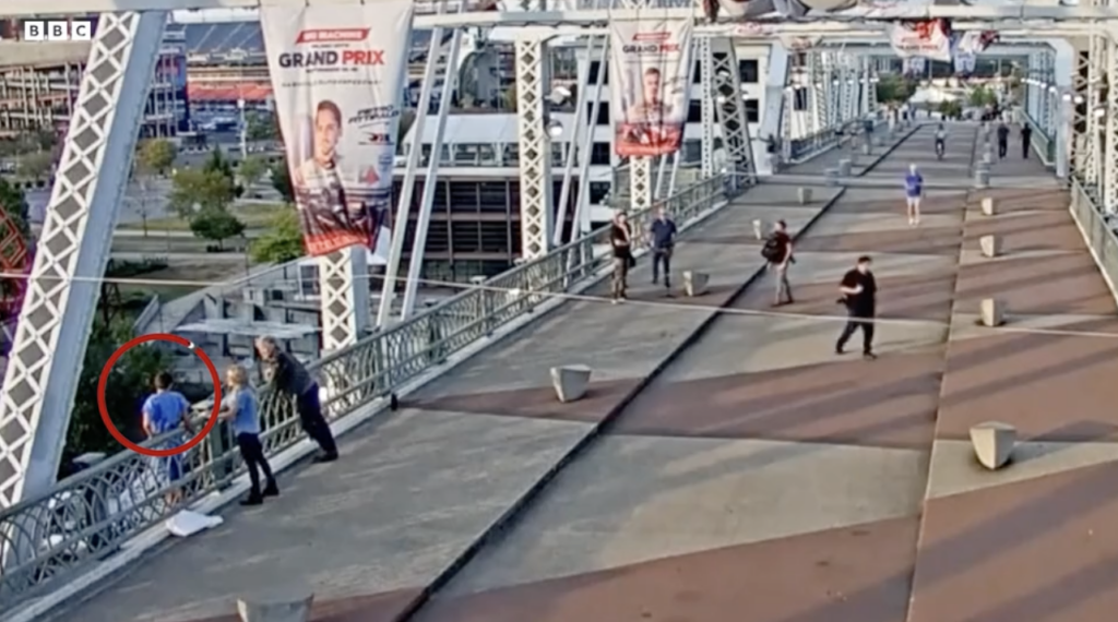 Jon Bon Jovi and friend talking to a woman on a bridge's railing